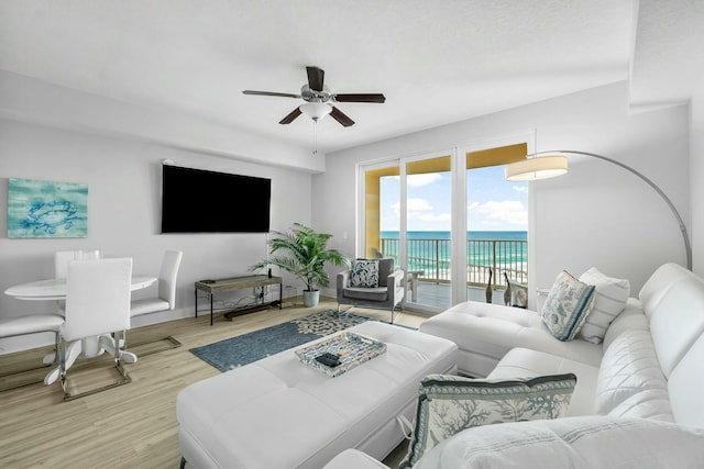 living room featuring light hardwood / wood-style flooring and ceiling fan