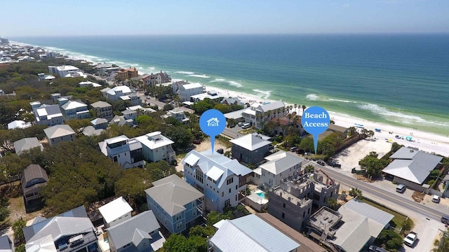 bird's eye view with a water view and a beach view