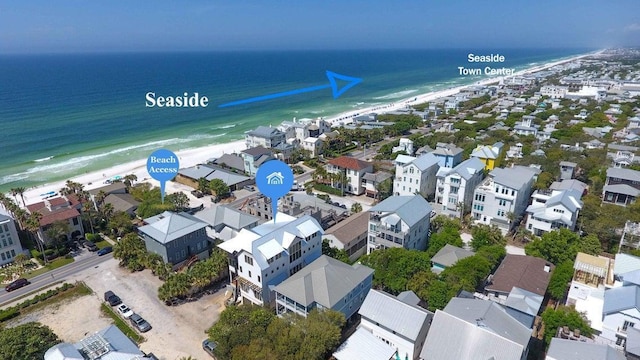 aerial view with a water view and a beach view