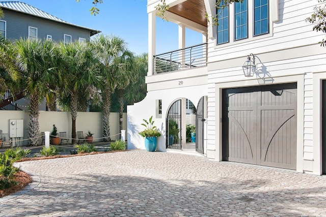 exterior space featuring a balcony and a garage