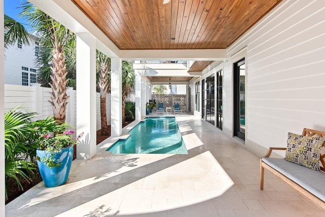 view of swimming pool with ceiling fan and a patio