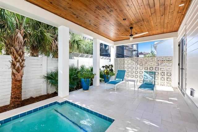 view of swimming pool featuring ceiling fan, a patio area, and a jacuzzi