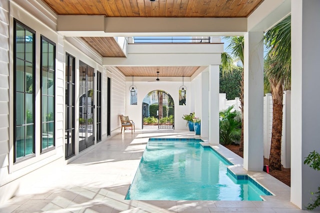 view of swimming pool featuring french doors and a patio area