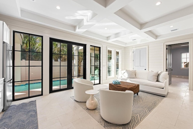 living room featuring beam ceiling, french doors, and coffered ceiling