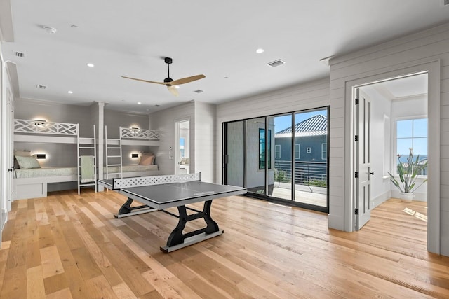 recreation room featuring light hardwood / wood-style flooring and ceiling fan