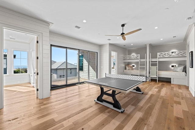 playroom with ceiling fan, light hardwood / wood-style floors, and crown molding