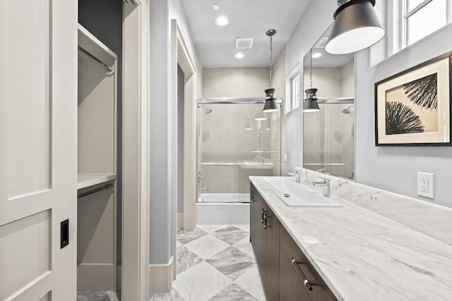 bathroom featuring vanity and bath / shower combo with glass door