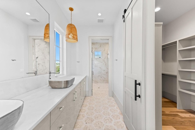 29 Thyme St, Santa Rosa Beach, FL 32459 - bathroom featuring a marble finish shower, double vanity, recessed lighting, and a spacious closet