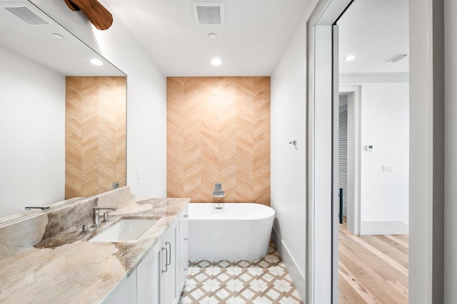 bathroom with a bathing tub and vanity