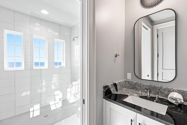 bathroom featuring vanity and a tile shower