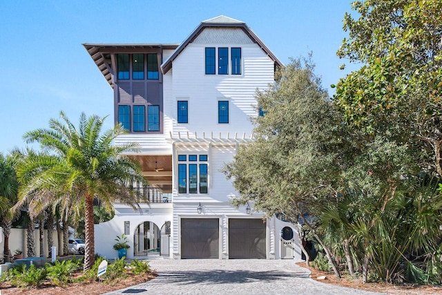 view of front of home with a balcony and a garage