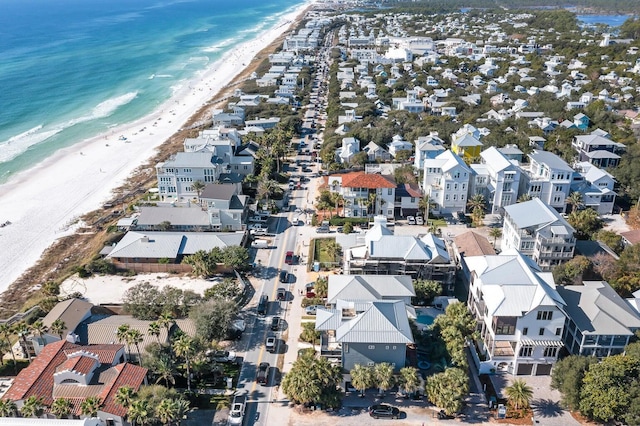 drone / aerial view featuring a beach view and a water view