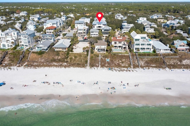 drone / aerial view with a water view and a beach view