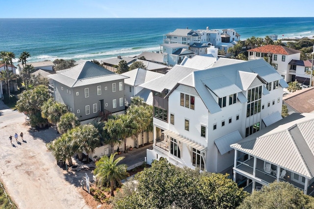 drone / aerial view with a water view and a beach view