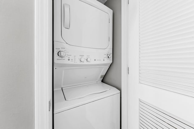 laundry room featuring stacked washer / drying machine