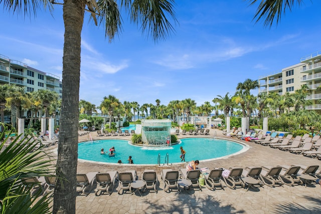 view of swimming pool featuring pool water feature and a patio