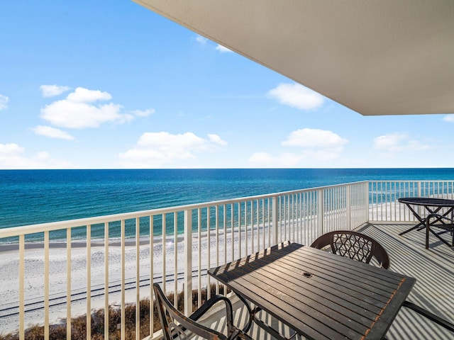 balcony featuring a beach view and a water view