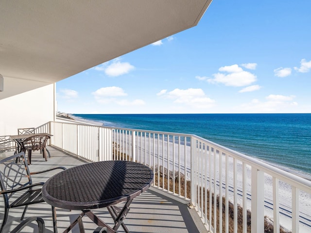 balcony featuring a beach view and a water view