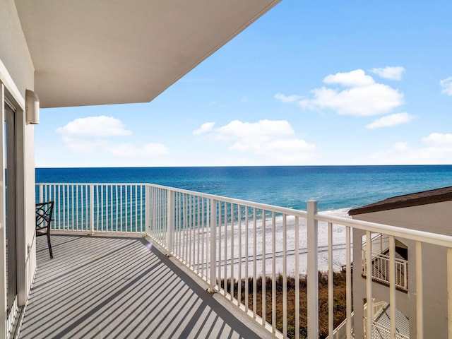 balcony featuring a beach view and a water view