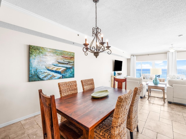 dining area with light tile patterned floors, baseboards, and a textured ceiling