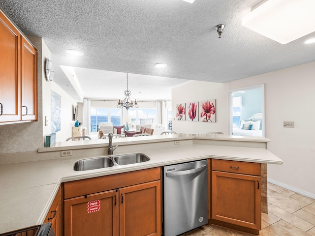 kitchen featuring brown cabinetry, a peninsula, light countertops, stainless steel dishwasher, and a sink