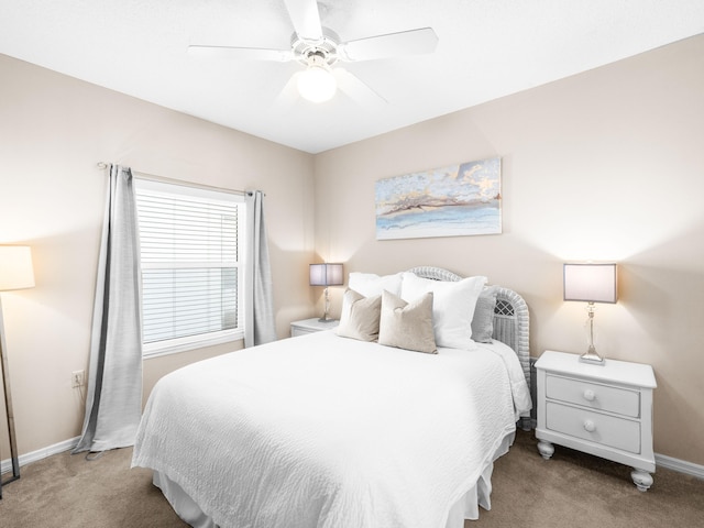 bedroom with ceiling fan, baseboards, and light colored carpet