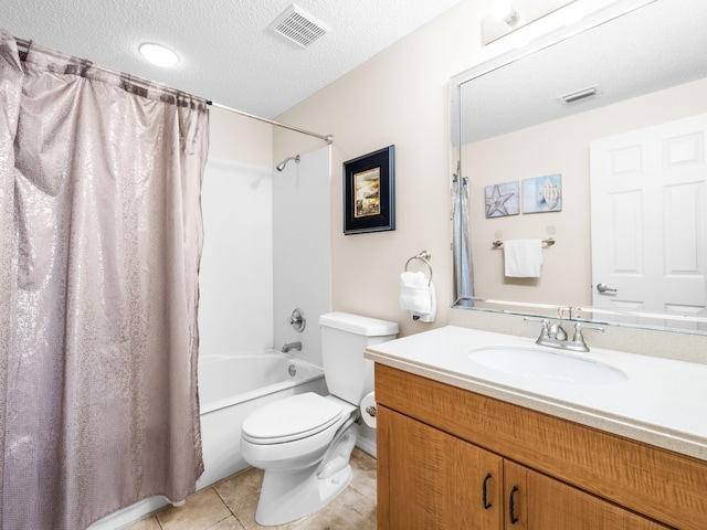 bathroom featuring visible vents, toilet, tile patterned flooring, a textured ceiling, and vanity