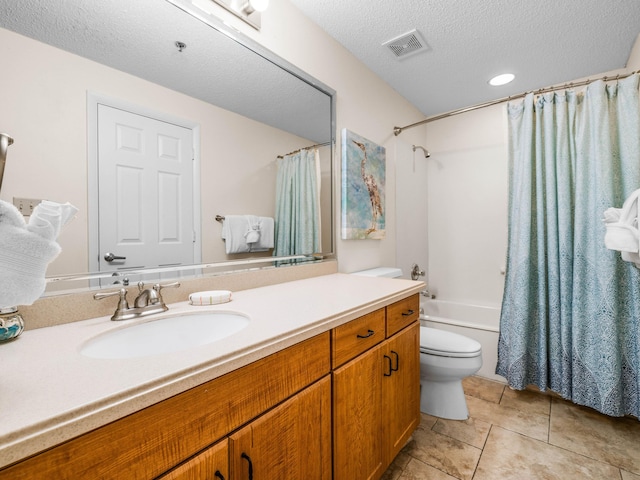 bathroom with visible vents, toilet, vanity, a textured ceiling, and tile patterned flooring