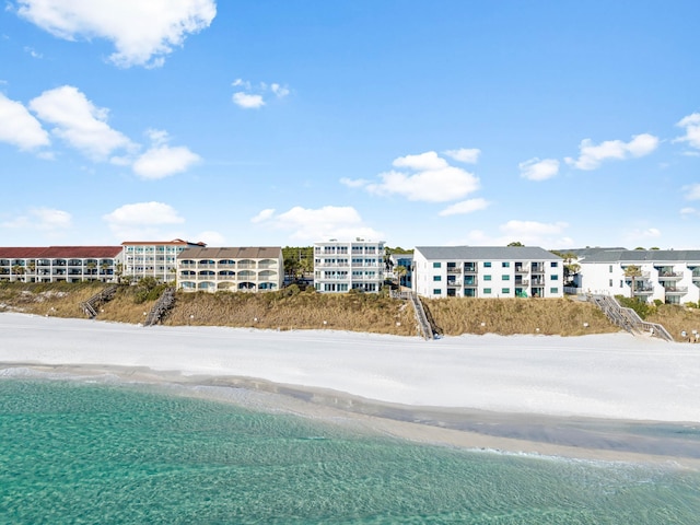 birds eye view of property with a water view and a view of the beach