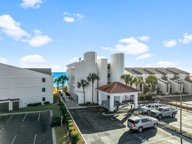 exterior space featuring a water view, curbs, and sidewalks