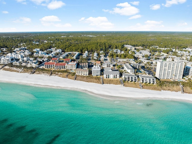 birds eye view of property with a water view and a beach view