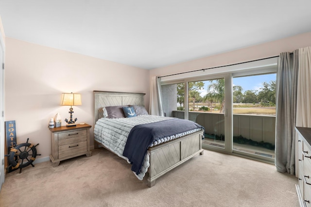 bedroom featuring access to outside and light carpet