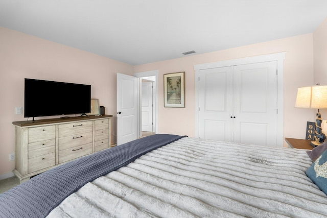 carpeted bedroom featuring a closet