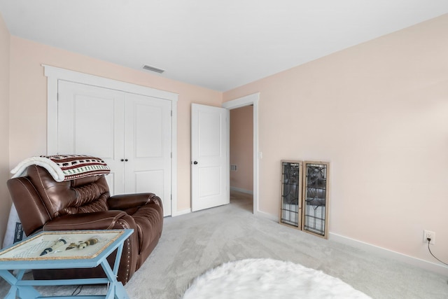 sitting room featuring light carpet