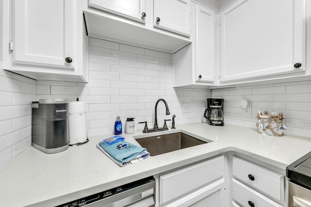 kitchen with sink, decorative backsplash, dishwashing machine, electric range oven, and white cabinetry