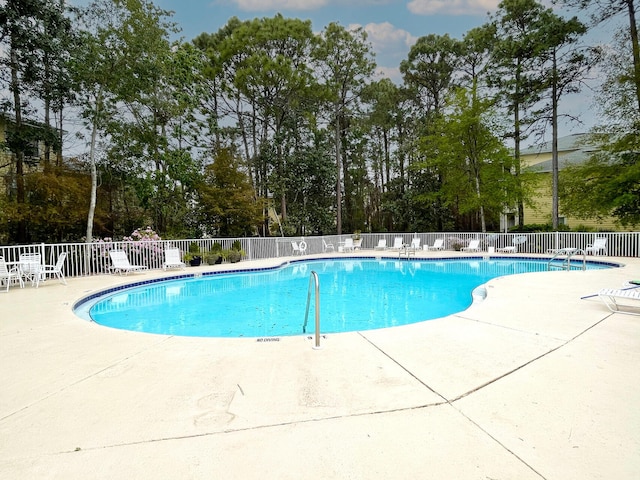 view of swimming pool with a patio