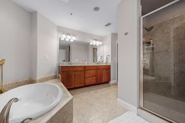 bathroom with tile patterned floors, vanity, and shower with separate bathtub