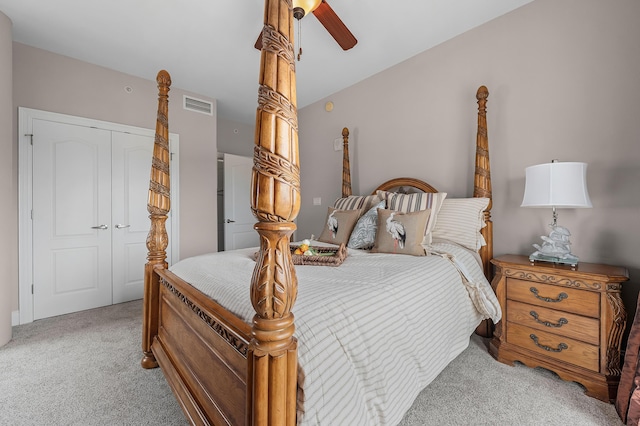 carpeted bedroom with ceiling fan and a closet