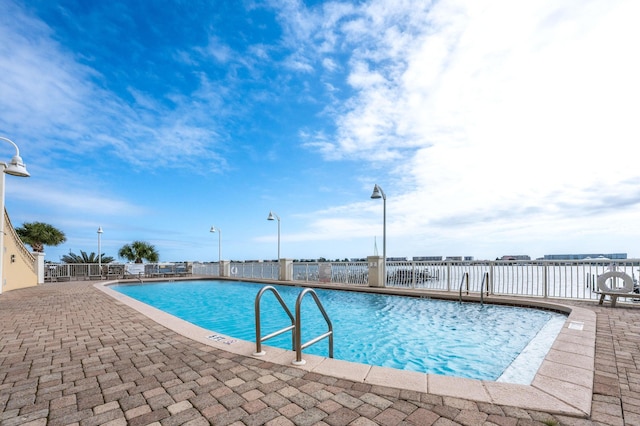 view of swimming pool featuring a patio area