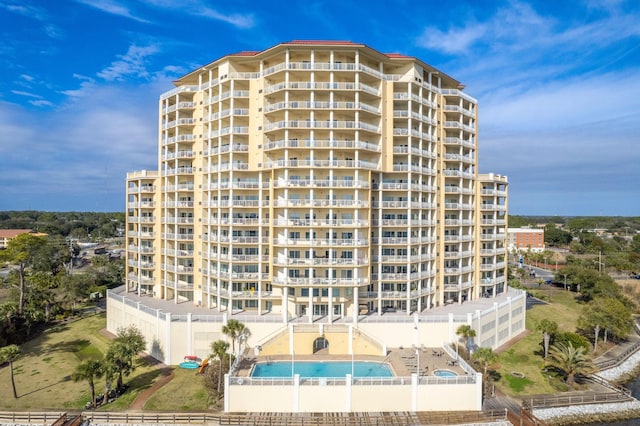 view of building exterior with a community pool