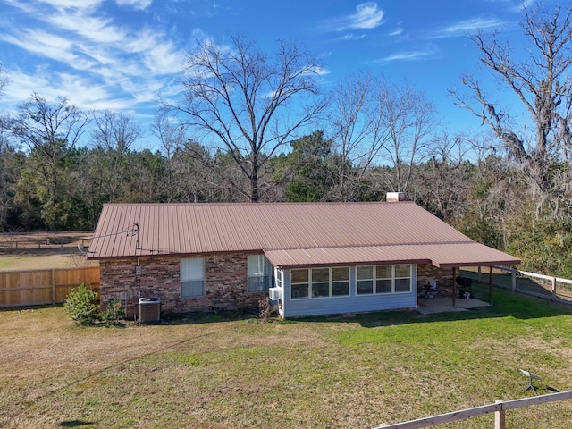 back of house with a lawn