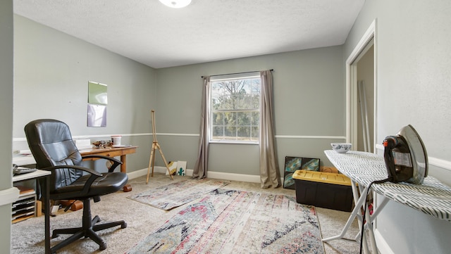 home office featuring carpet and a textured ceiling