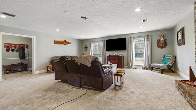 living room featuring light carpet and a textured ceiling