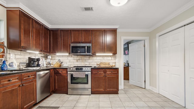 kitchen with sink, stainless steel appliances, tasteful backsplash, light tile patterned floors, and ornamental molding