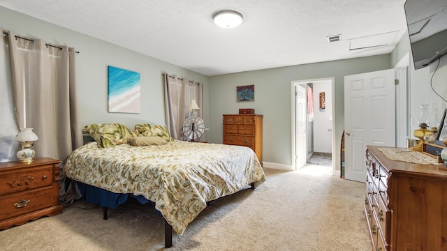 bedroom with a textured ceiling and light carpet