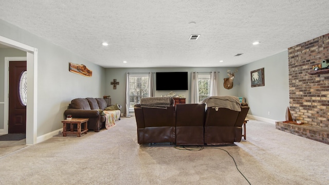 living room featuring a textured ceiling, a fireplace, and light carpet