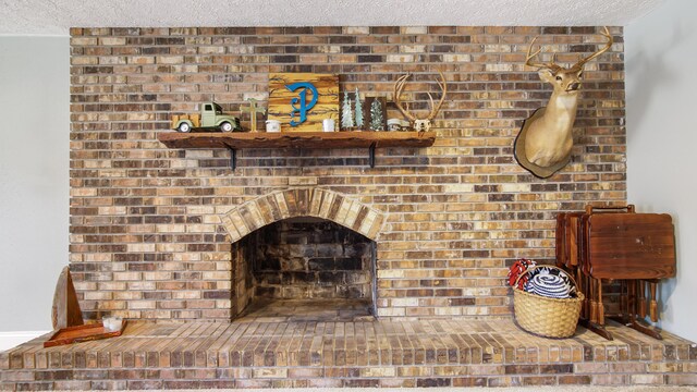 interior details featuring a fireplace and a textured ceiling