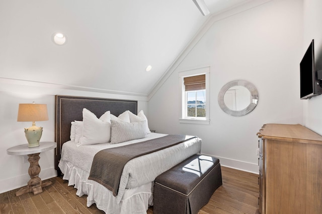 bedroom featuring dark hardwood / wood-style floors, lofted ceiling, and ornamental molding