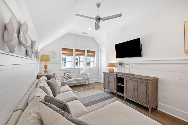 living room with dark hardwood / wood-style flooring, vaulted ceiling, and ceiling fan