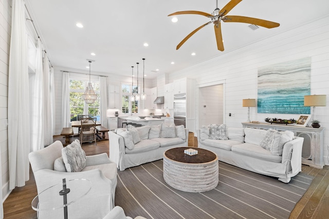 living room with dark hardwood / wood-style floors and ceiling fan